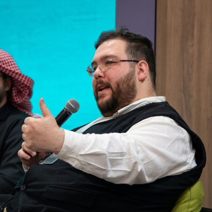 Salahudean speaking into a microphone at a panel event